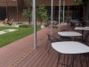 Covered composite deck with outdoor tables and chairs beside the container cafe