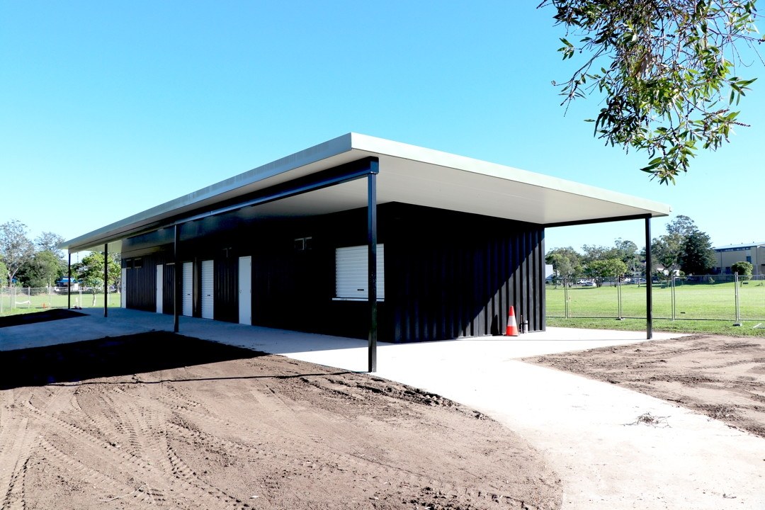 Multi-use shipping container amenities block with flyover roof and white doors for Australian councils and sporting clubs — Container Build Group