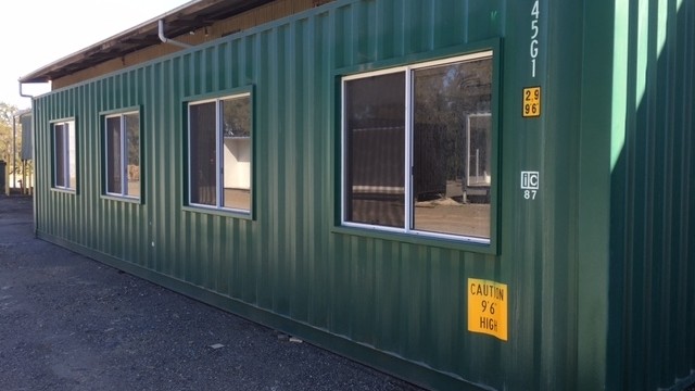 Remote mining cabin exterior — 40ft high-cube with sliding windows