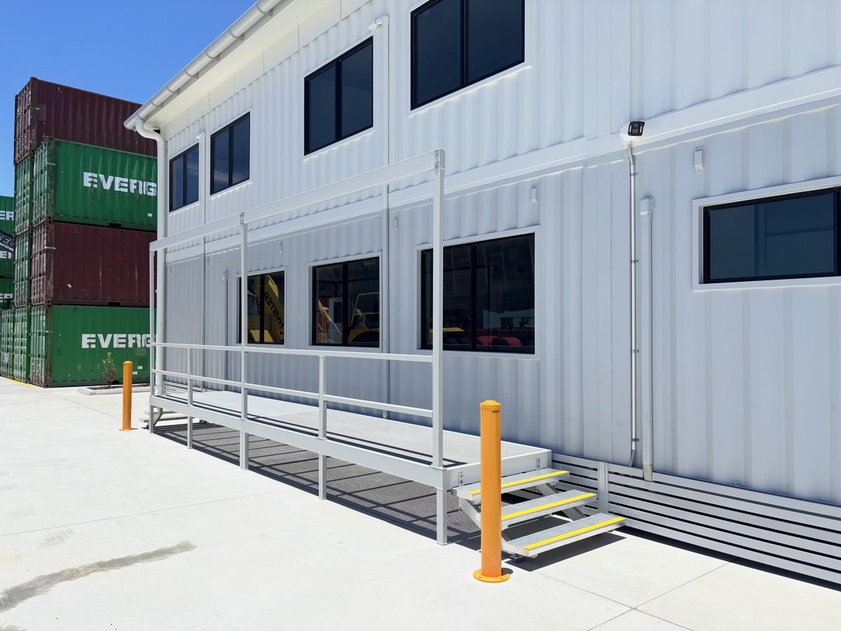 White multi-level container building with access walkway at Port of Brisbane — Container Build Group