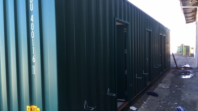 Container mining cabin exterior showing separate access doors to four bedrooms