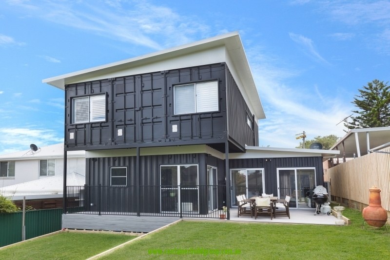 Rear exterior of Cronulla two-storey container home with deck and lawn — Container Build Group