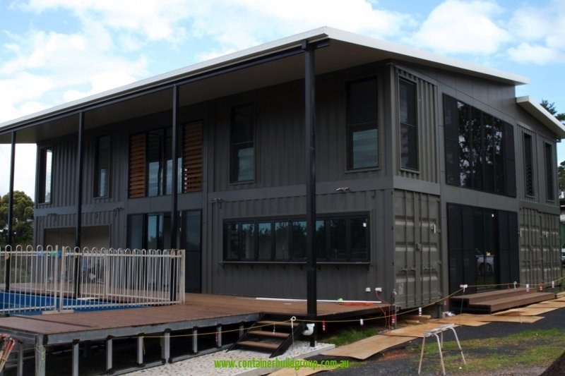The Lindendale two-storey container home exterior with deck and pool fence