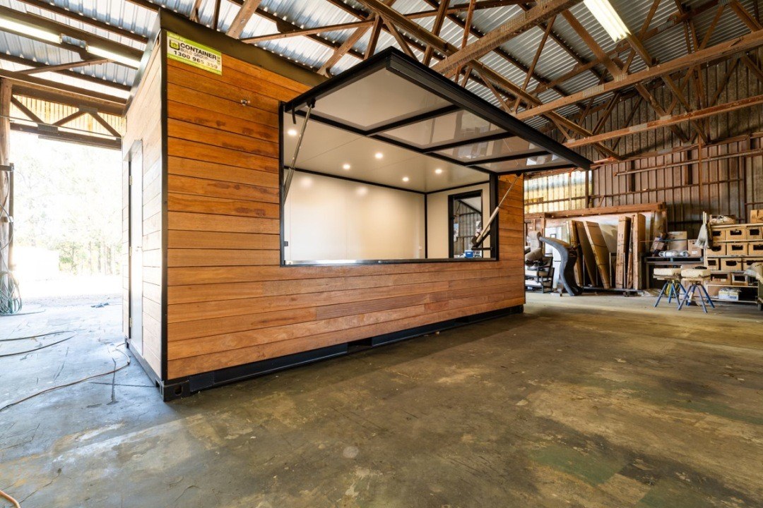 Timber-clad container cafe for Noosa Hills Golf Club with the serving hatch open
