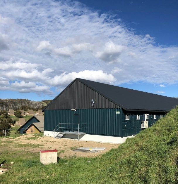 Snowy Hydro 32-man alpine lodge exterior on sloping site
