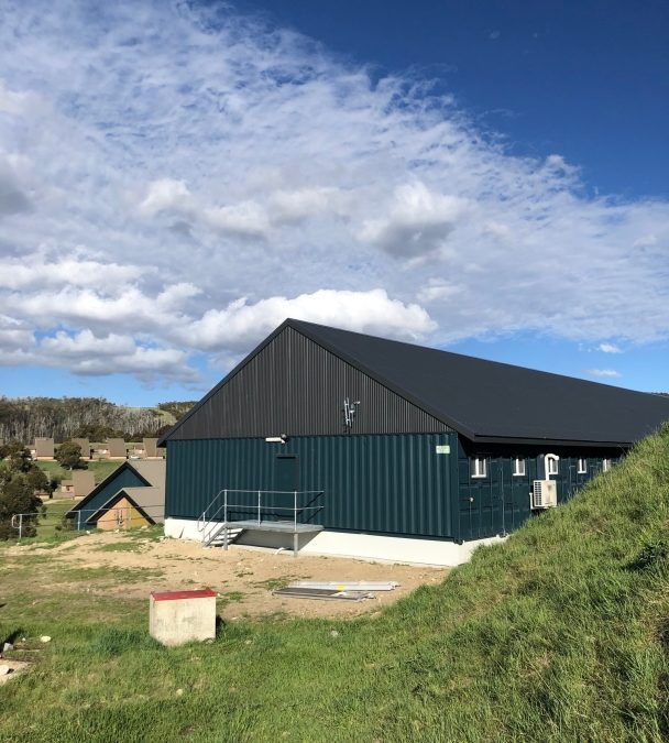 Snowy Hydro 32-man alpine lodge exterior on sloping site