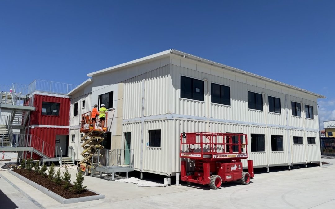 Three-level red and white shipping container commercial building at Port of Brisbane expansion by Container Build Group