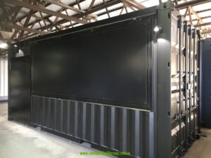 Black 20ft commercial kitchen container exterior with lights above the closed servery panel