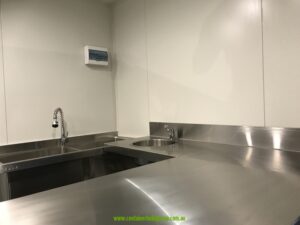 Stainless steel sinks and splashback inside a 20ft commercial kitchen container