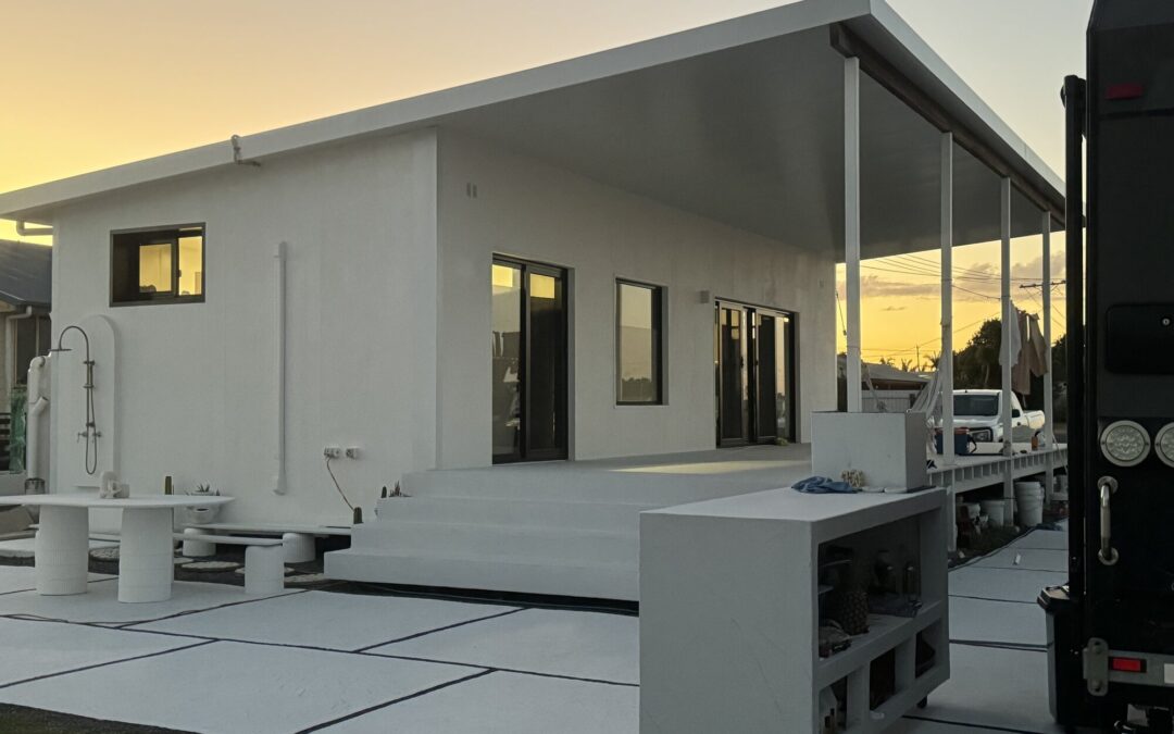 Burnett Heads granny flat at sunset — two-container clad exterior with covered deck and outdoor living