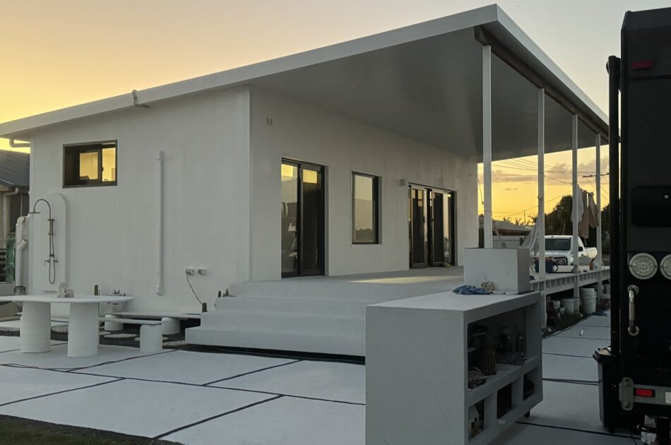 Burnett Heads granny flat at sunset — two-container clad exterior with covered deck and outdoor living