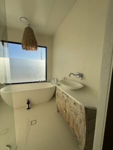 Fully tiled bathroom with freestanding bath — Burnett Heads granny flat