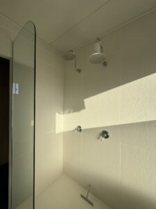 Dual shower detail, fully tiled — Burnett Heads granny flat